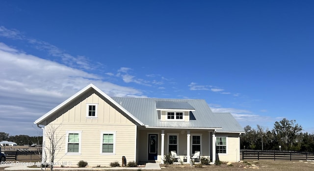 rear view of property with covered porch