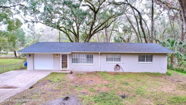 ranch-style house with a garage and a front yard