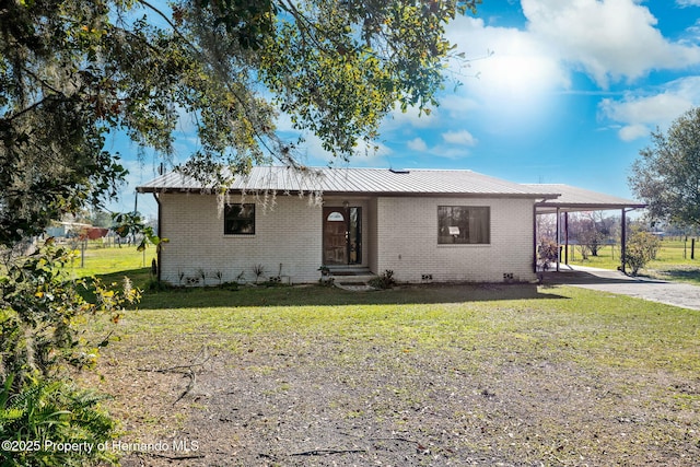 ranch-style home with a carport and a front yard