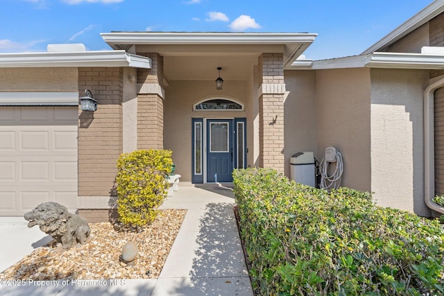 view of exterior entry with a garage