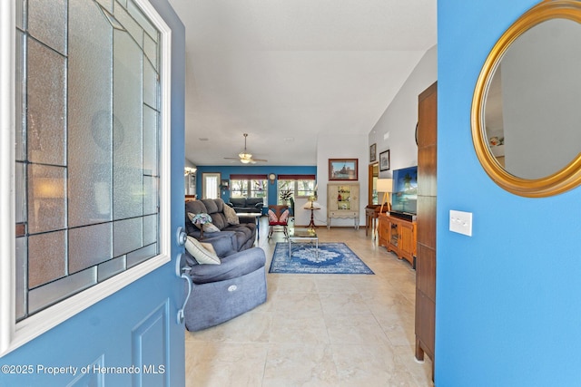 tiled living room featuring vaulted ceiling and ceiling fan