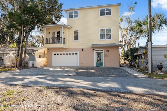 view of property featuring a balcony and a garage