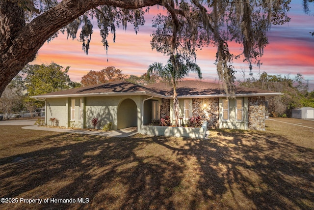 ranch-style home featuring a lawn