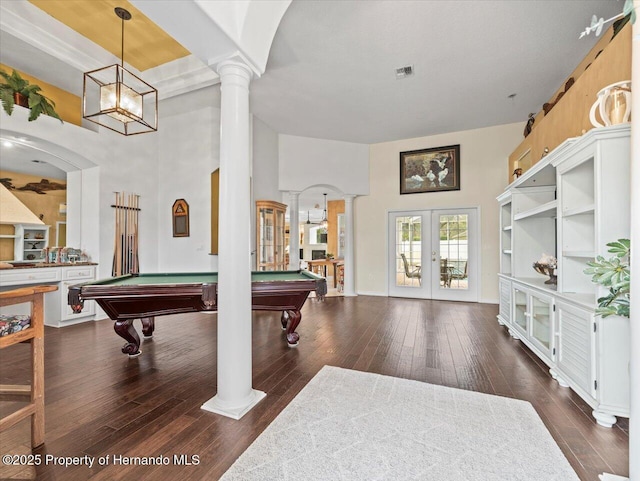 rec room featuring french doors, dark hardwood / wood-style flooring, and decorative columns