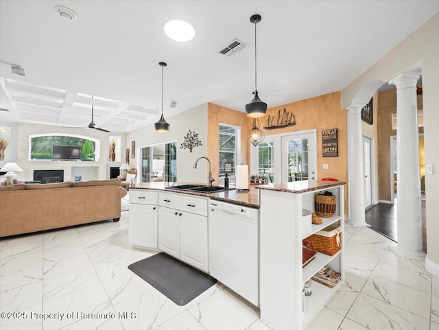 kitchen with pendant lighting, decorative columns, white dishwasher, coffered ceiling, and an island with sink