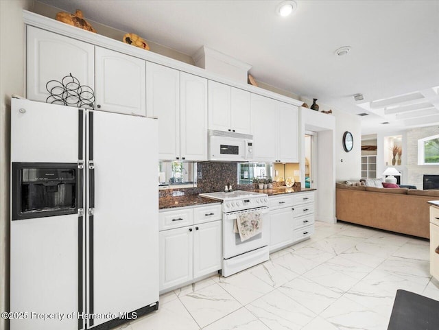 kitchen with white cabinetry, white appliances, decorative backsplash, and dark stone countertops