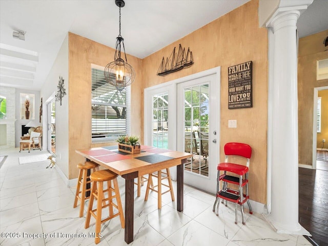 dining room featuring decorative columns