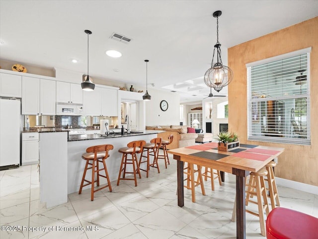 dining room featuring wooden walls and sink