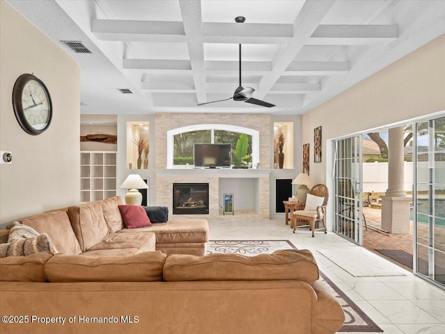 living room with ceiling fan, coffered ceiling, decorative columns, and beam ceiling