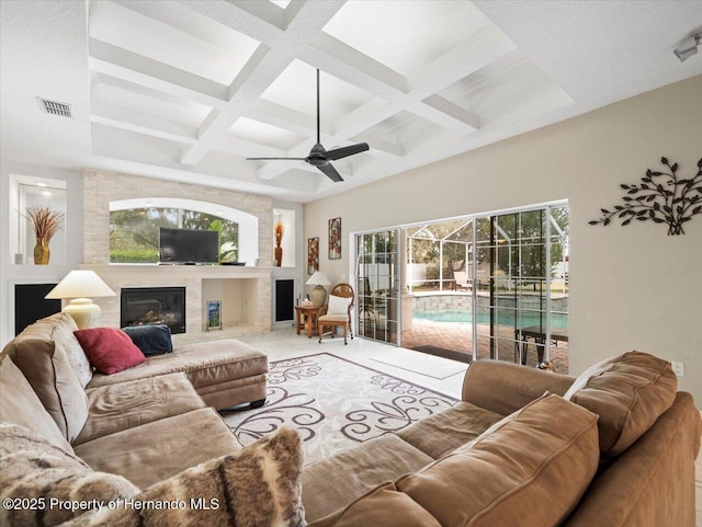 living room with coffered ceiling, beam ceiling, and ceiling fan