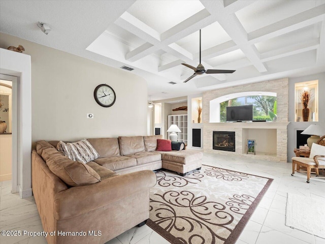 living room with beamed ceiling, coffered ceiling, and ceiling fan