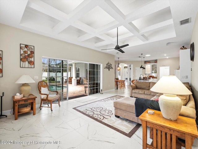 living room featuring ceiling fan, coffered ceiling, and beam ceiling