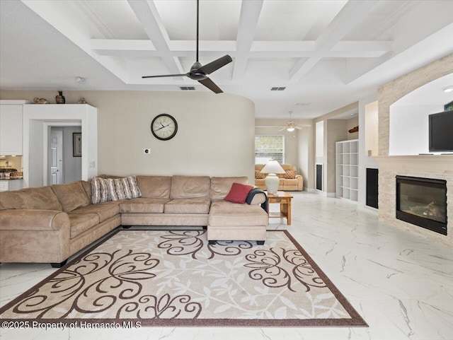 living room with coffered ceiling, ceiling fan, and beamed ceiling