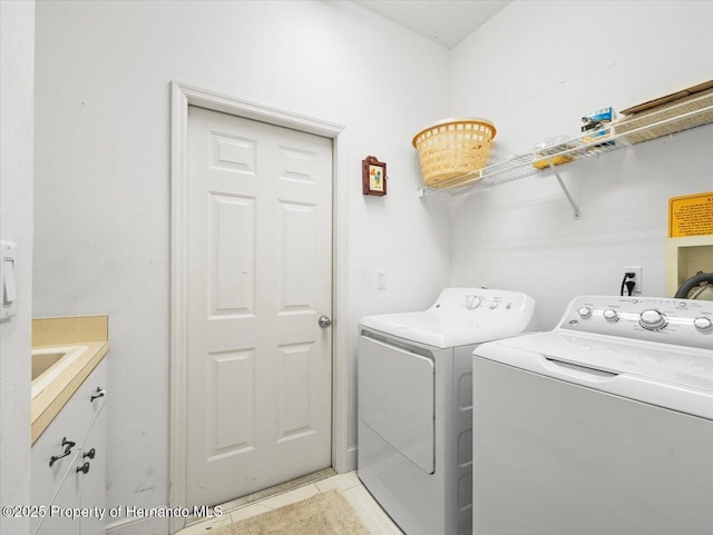 washroom featuring cabinets, light tile patterned floors, and independent washer and dryer