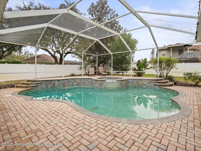 view of pool with an in ground hot tub, a lanai, and a patio