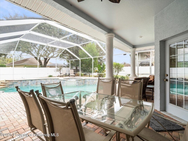 exterior space featuring a fenced in pool, ceiling fan, and glass enclosure