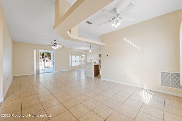 tiled empty room with ceiling fan