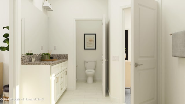 bathroom with tile patterned flooring, vanity, and toilet