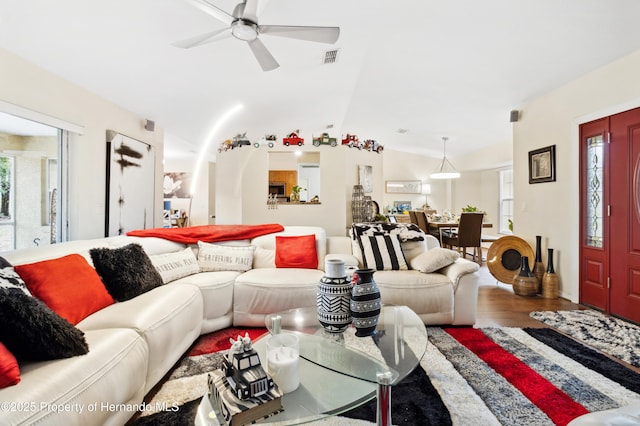 living room featuring wood-type flooring, plenty of natural light, lofted ceiling, and ceiling fan