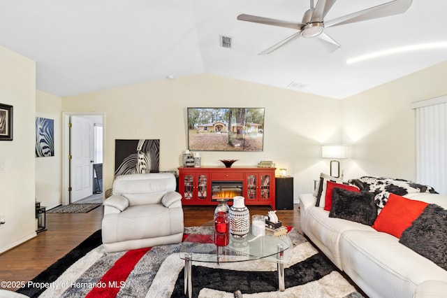 living room featuring hardwood / wood-style flooring, vaulted ceiling, and ceiling fan