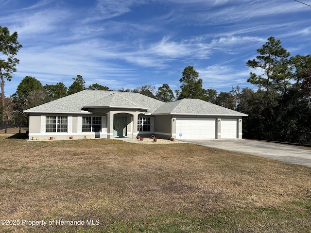 ranch-style house featuring a garage and a front lawn