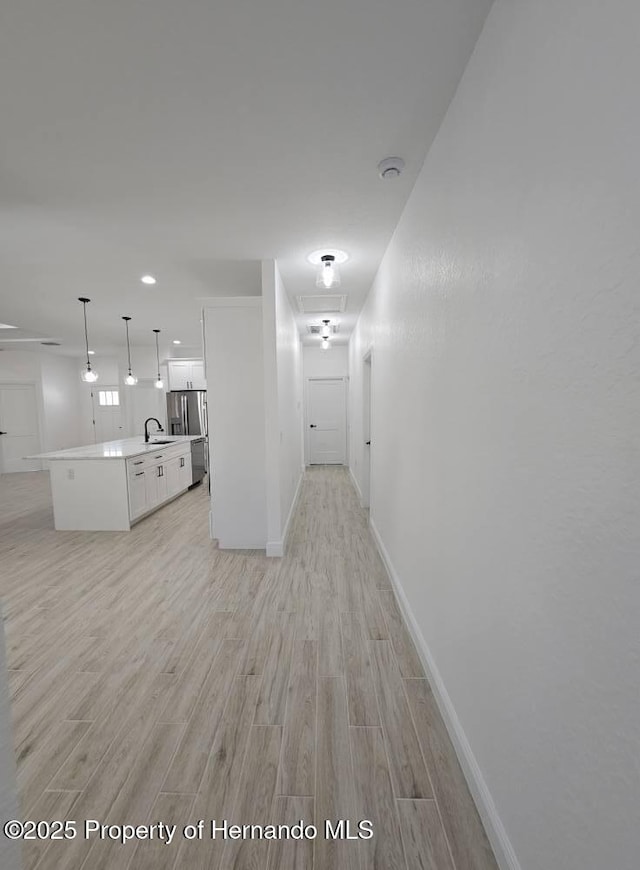 interior space with light hardwood / wood-style floors and sink