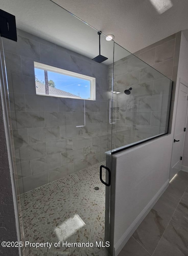 bathroom with a shower with shower door