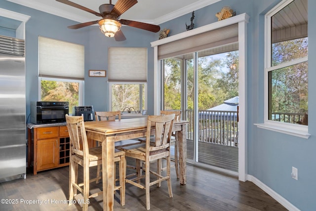 dining space with crown molding, ceiling fan, and hardwood / wood-style floors