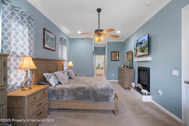 bedroom featuring ornamental molding, light colored carpet, and ceiling fan