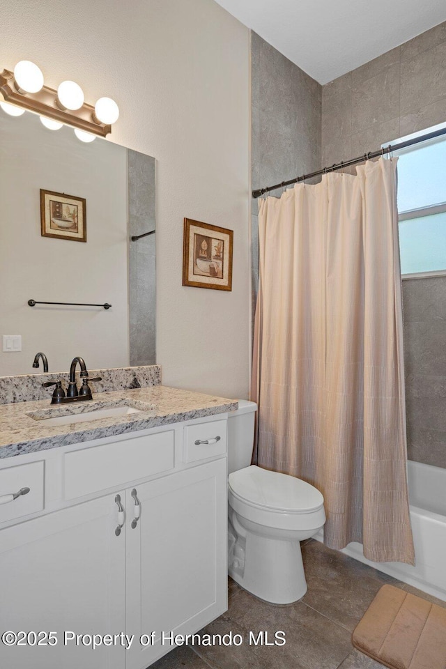 full bathroom featuring shower / tub combo with curtain, vanity, toilet, and tile patterned floors