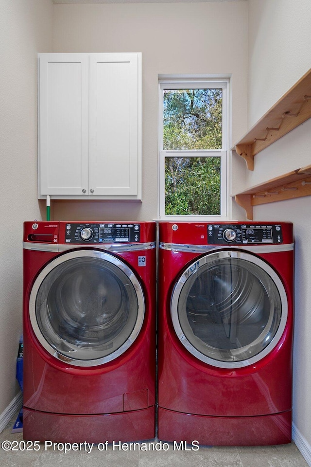 laundry room with cabinets and washing machine and dryer