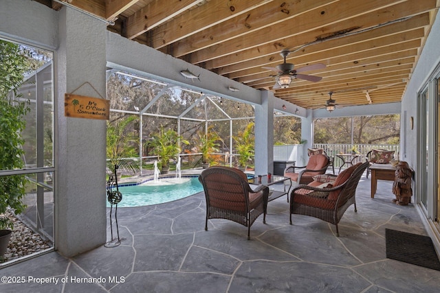 view of patio / terrace with a lanai, outdoor lounge area, and ceiling fan