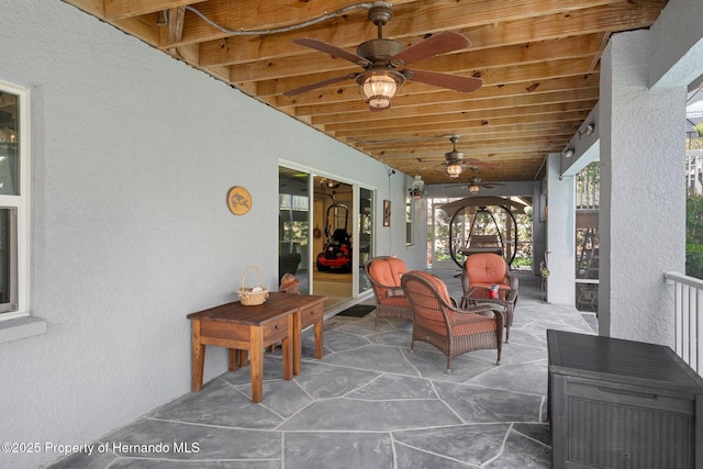 sunroom featuring wood ceiling and ceiling fan