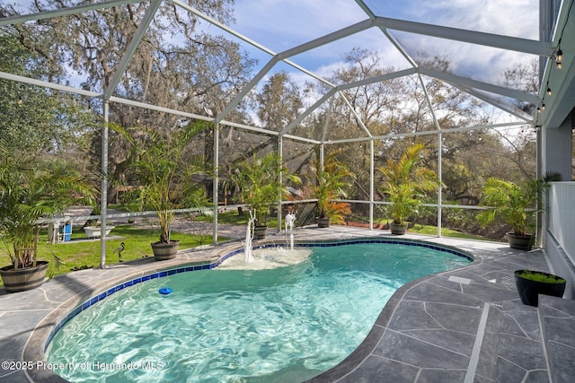 view of pool featuring a patio, pool water feature, and glass enclosure