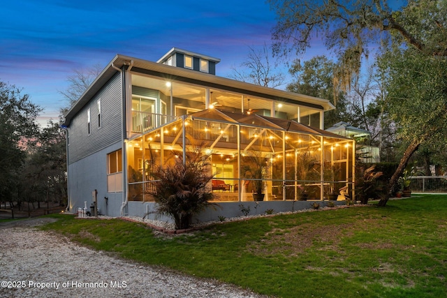 exterior space with a lawn and a balcony