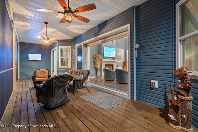 wooden terrace featuring ceiling fan