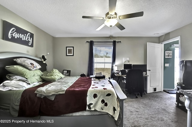 bedroom with carpet, a textured ceiling, and ceiling fan