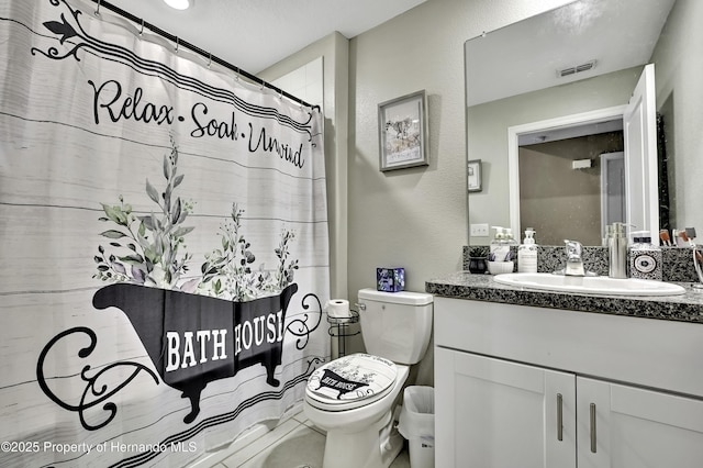 bathroom featuring vanity, toilet, and a shower with shower curtain