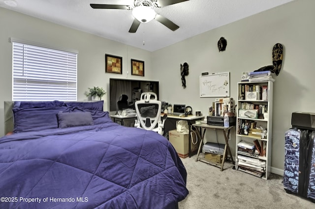 carpeted bedroom with a textured ceiling and ceiling fan