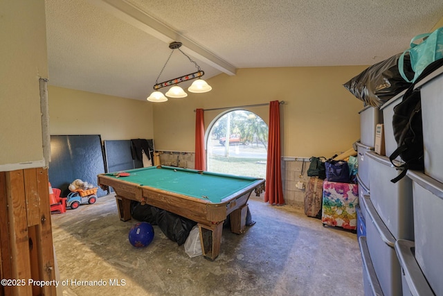 game room with pool table, lofted ceiling with beams, and a textured ceiling