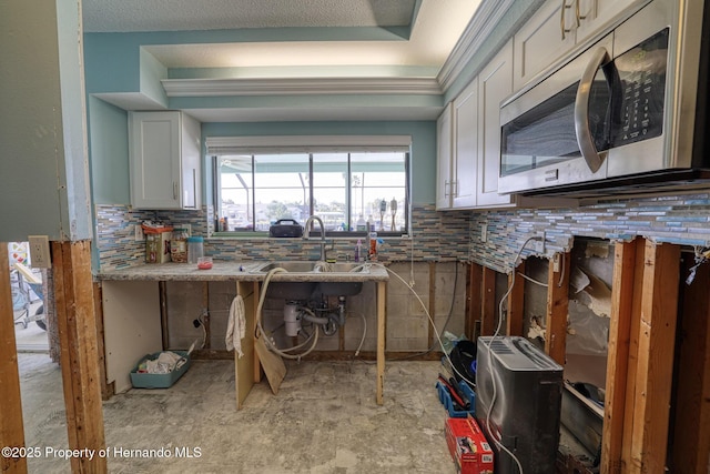 kitchen featuring sink and white cabinets