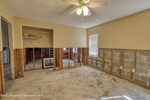 spare room featuring ceiling fan, washer / dryer, and a textured ceiling