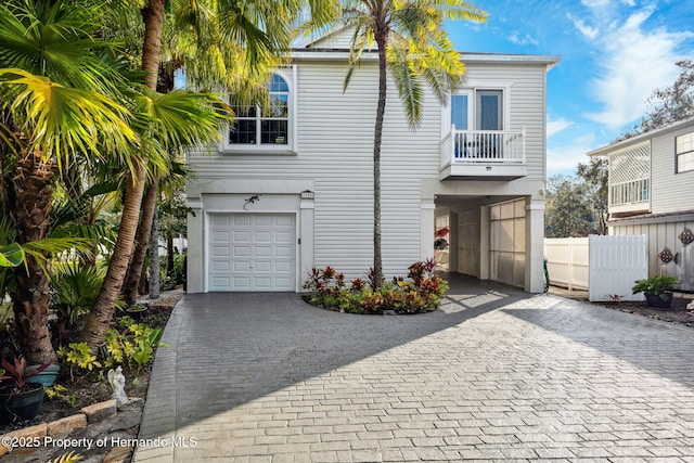 view of front of home with a garage and a balcony