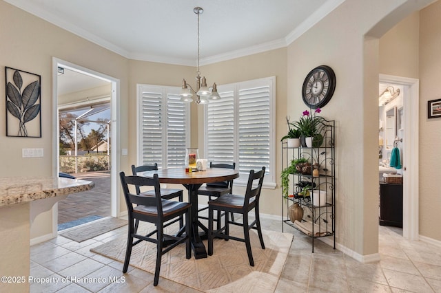 tiled dining space with an inviting chandelier, crown molding, and plenty of natural light