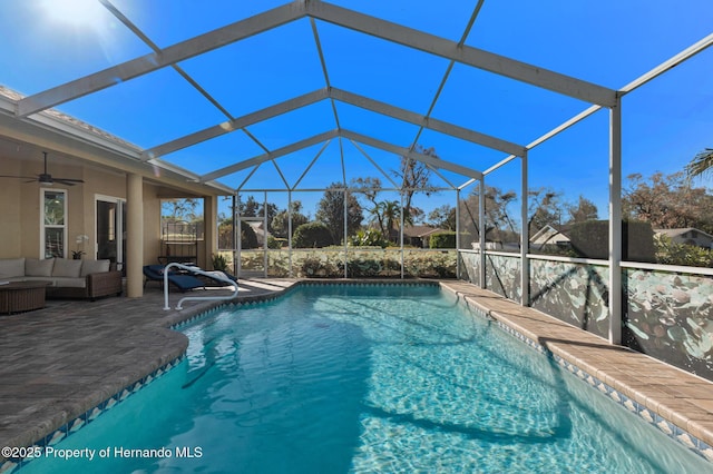 view of swimming pool featuring a lanai, an outdoor hangout area, ceiling fan, and a patio area