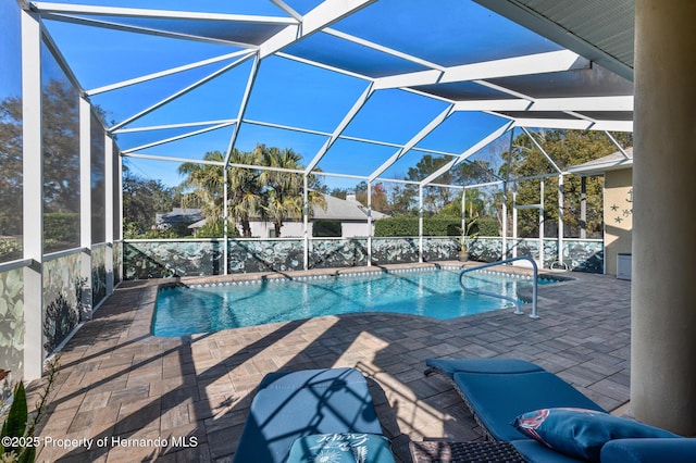 view of pool featuring a patio and glass enclosure