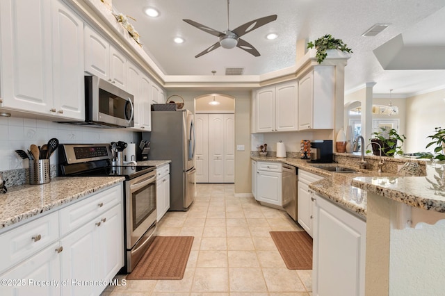 kitchen featuring appliances with stainless steel finishes, sink, and white cabinets