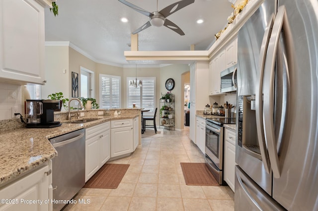 kitchen with white cabinetry, sink, decorative light fixtures, and stainless steel appliances