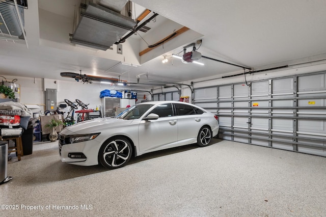 garage with a garage door opener and electric panel