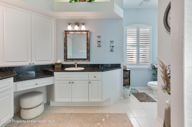 bathroom featuring tile patterned flooring, vanity, and toilet